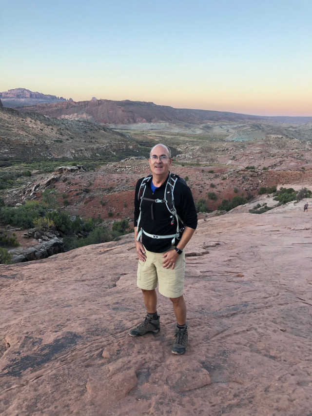 Steve taking a break from hiking and enjoying the beautiful scenery from afar. 