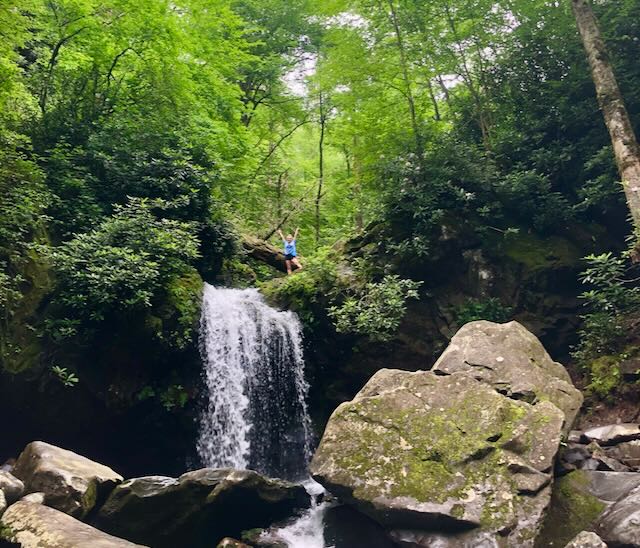 A view of Haleigh Standing on top of Grotto Falls