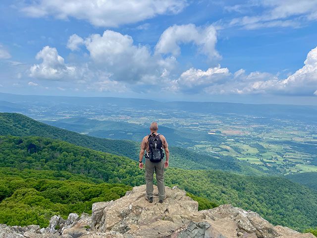 Steve is standing at the summit of Stony Man Trail with a view of Page Valley. 