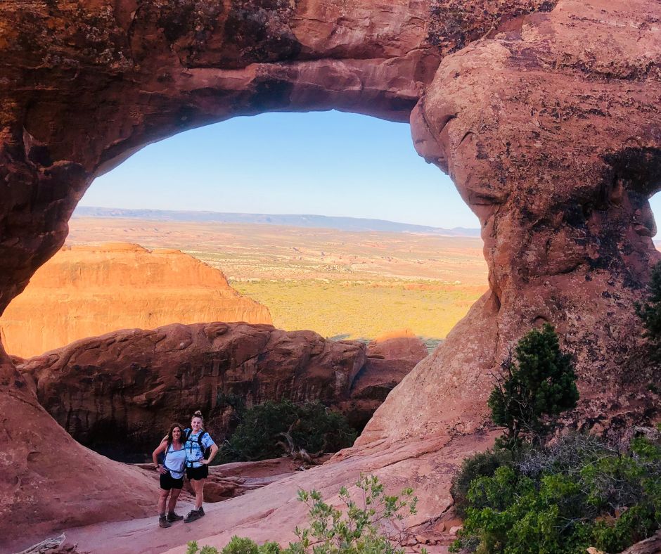 Lori and Haleigh are standing in front of Partition Arch