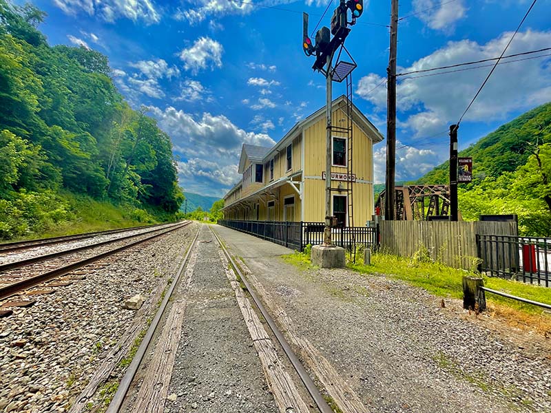 A picture showing the Thurmond Passenger Depot with a long set of railroad tracks