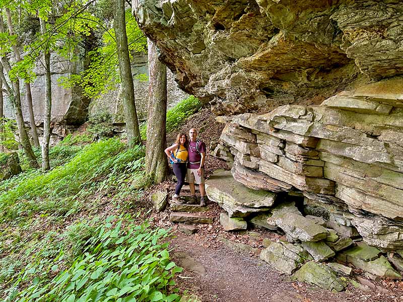 Lori and Steve hiking next to the sandstone walls on the tunnel ridge trail.  