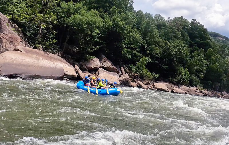 white water rafters paddling down the New River.    